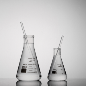 Closeup shot of two tubes inside Erlenmeyer beakers